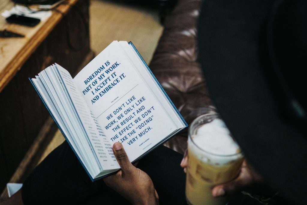 Someone looking something up in a book.