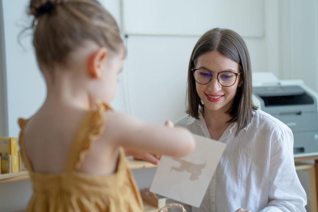 Little girl does something that mother asks her to do.