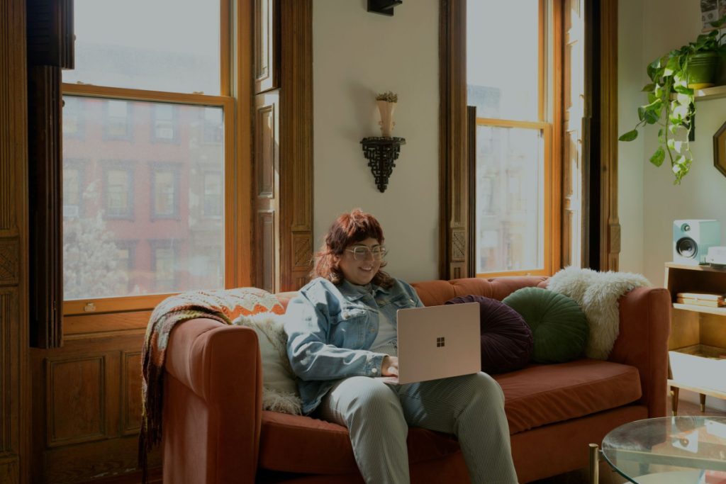 Woman on sofa watching a video clip.